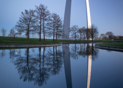 A photo of the Arch reflected in a pond.