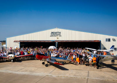 The attendees pose with the aircraft.