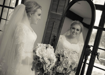 The bride reflected in a mirror before the wedding.