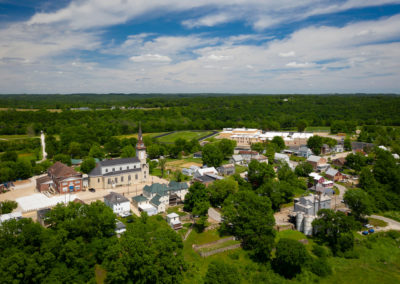 A drone photograph of a small town and church during the Spring.