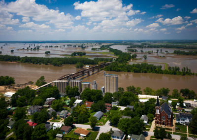 An image from above of a flooded rivertown.