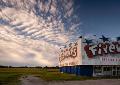 A photo of a fireworks store with a cloudy sky.