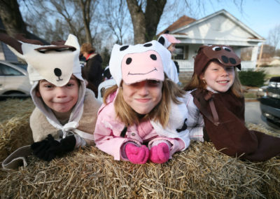 Kids pose for a photo on a parade float.