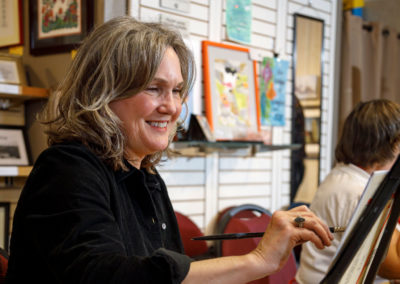 An adult at a painting class.