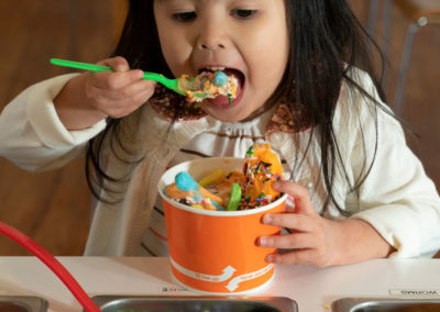 A child eating a sundae.