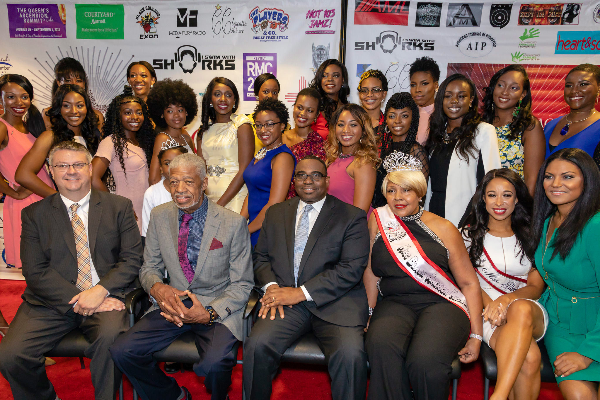 A photograph of dignitaries and pageant contestants.
