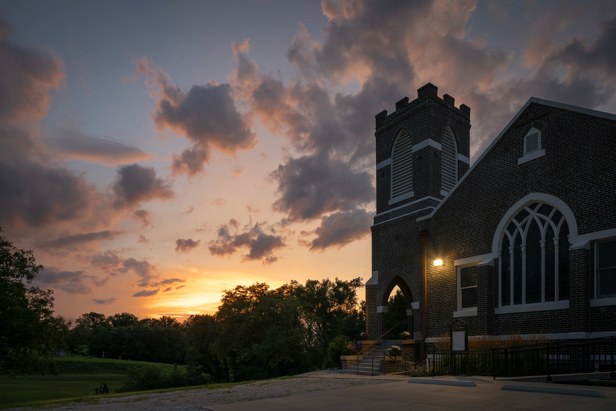 A photograph of a church at sunset.