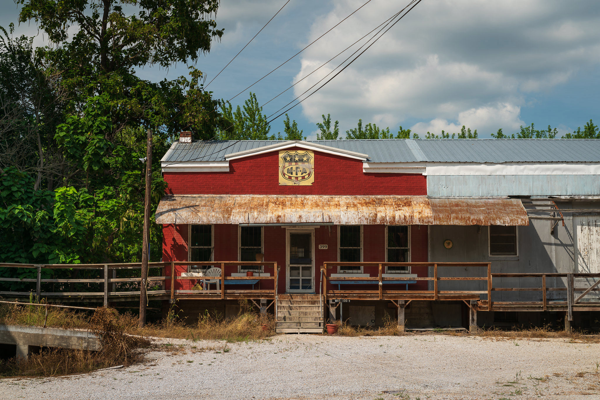 A photograph of a rural feed store with a cloudy sky.