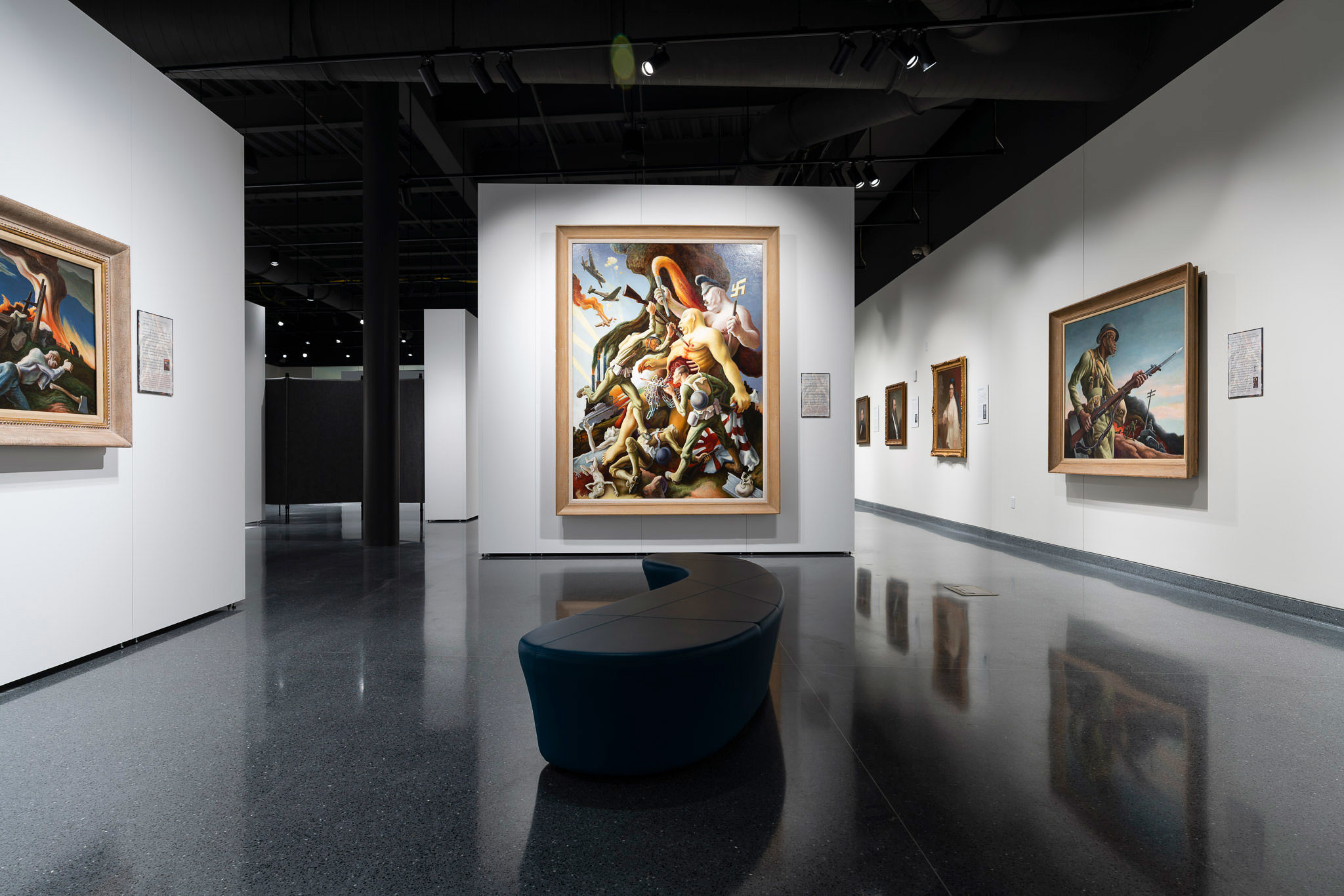 An interior photo of a museum featuring the work of Thomas Hart Benton.